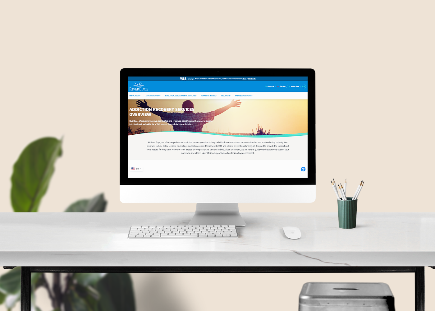 Desktop monitor displaying River Edge Behavioral Health homepage